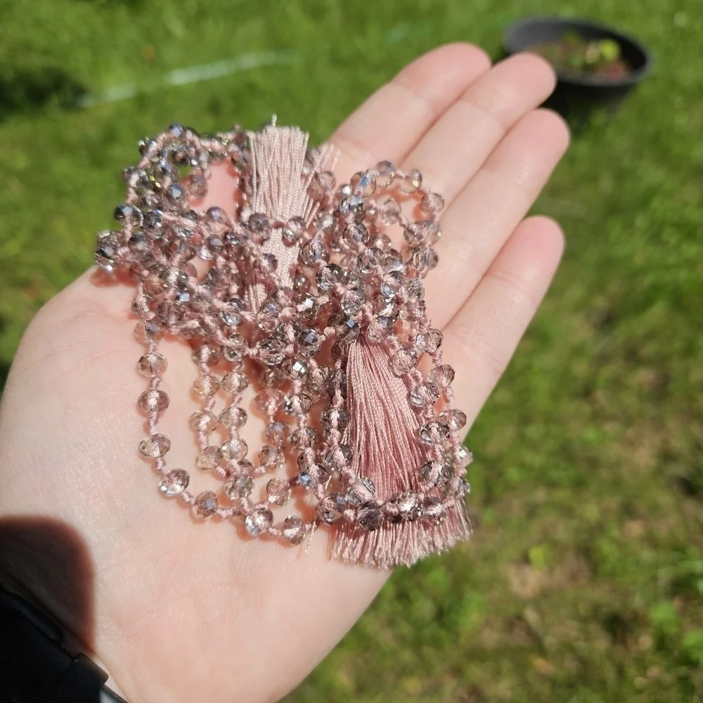 clear gray crystal beads on mauve cording with tassels